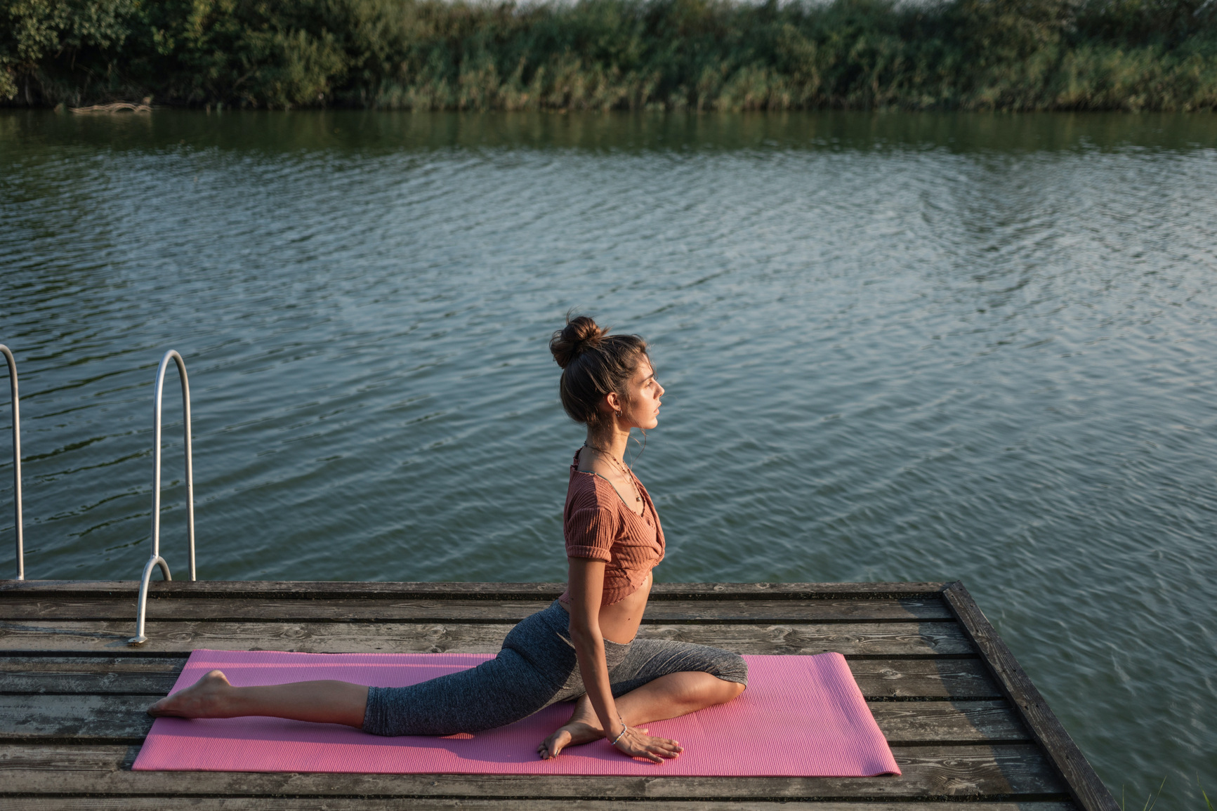 Woman enjoying morning yoga near Green Lake.