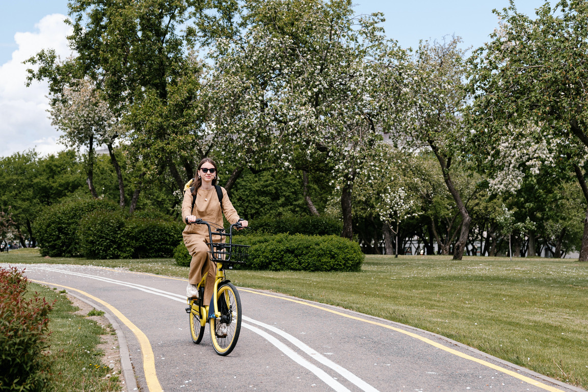 Woman on bike enjoying Green Lake bike trails located nearby Iron Flats apartments.